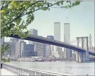  ??  ?? Twin Towers soar into the sky behind the Brooklyn Bridge before attack in New York