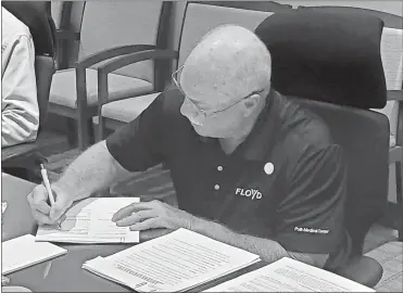  ?? Jeremy stewart, File ?? In March , Cedartown-Polk Hospital Authority Chairman Frank Shelley signs one of the resolution­s amending and restating the group’s lease with Polk Medical Center Inc. as part of the proposed merger.