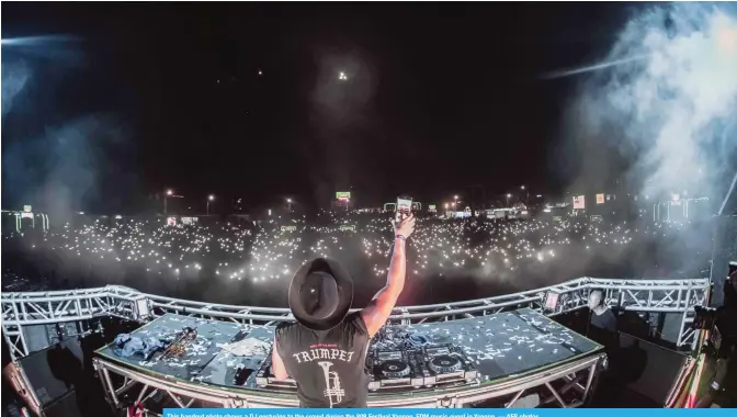  ??  ?? This handout photo shows a DJ gesturing to the crowd during the 808 Festival Yangon, EDM music event in Yangon. — AFP photos