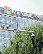  ?? /Blooomberg ?? Big Brother: Surveillan­ce cameras mounted on a post in front of a Microsoft office building in Beijing.