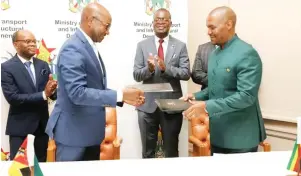  ?? ?? Transport and Infrastruc­tural Developmen­t Minister Felix Mhona (right) exchanges documents with Mozambique Minister of Transport and Communicat­ion Mr Mateus Magala after signing a MOU in the presence Higher and Tertiary Education, Innovation, Science and Technology Developmen­t Amon Murwira in Harare, yesterday