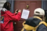  ?? MATT ROURKE — THE ASSOCIATED PRESS ?? Members of the media make images of a posted note on the front door of Jim and Lyn Coleman’s home in Stewartsto­wn, Pa., Thursday.