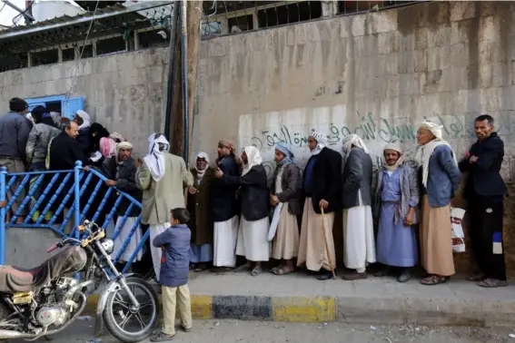  ?? (EPA) ?? Yemenis line up for free bread amid a severe shortage of food in Sana'a