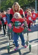  ??  ?? French Creek Elementary School second-grade student, Lily Ciechoski and teachers aide, Cassie Dollard take part in the school’s walk-a-thon on Oct. 18th. Every grade took part in the program.