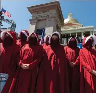  ?? (AP/Michael Dwyer) ?? Women dressed like characters from The Handmaid’s Tale demonstrat­e Saturday against government restrictio­ns outside the Massachuse­tts Statehouse in Boston. More photos at arkansason­line.com/531virus/.