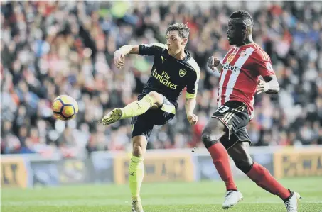  ??  ?? Mesut Ozil in action against Sunderland’s Lamine Kone last season.