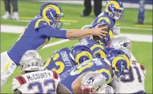  ?? Keith Birmingham / Associated Press ?? Rams quarterbac­k Jared Goff, left, dives for a touchdown against the Patriots during the first half of their game Thursday. Goff also threw a TD pass.