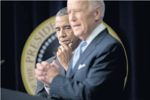  ??  ?? NO CLEAN BREAK: President Barack Obama listens to Vice President Joe Biden at the White House in December 2016. Mr Biden came to the debate stage armed with stats and one-liners aimed at the feisty group of challenger­s. But the weapon he used the most was just two words: Barack Obama.