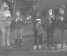  ?? MARA LAVITT/SPECIAL TO THE COURANT ?? A candleligh­t vigil, attended by members of Mothers United Against Violence, is held in memory of Luz Rosado outside her Hartford family’s home last year.