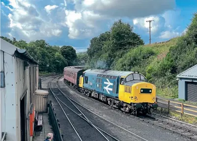  ?? ANDREW JEFFERY ?? NYMR-based Class 37 No. 37264, now with black headcode panels, heads the 09.55 Pickering–Grosmont on August 10. It is seen passing Grosmont shed, between NELPG’s Deviation shed and Armstrong Oilers, where most of the world’s underkeep pads are made.