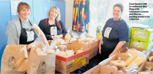  ??  ?? Food Basket CHB co-ordinator Mel King with volunteers Lauren and Sharon, packing boxes to be collected.