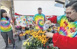  ?? Irfan Khan Los Angeles Times ?? TRADER JOE’S workers wear tie-dye T-shirts to honor Melyda Corado, the 27-year-old store manager who was fatally struck by a police officer’s bullet.