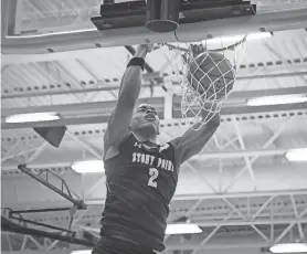  ?? JOHN GUTIERREZ/SPECIAL TO AMERICAN-STATESMAN ?? Stony Point forward Josiah Moseley dunks the ball in Friday’s win at Manor. Moseley had 36 points, 13 rebounds, six assists and five blocks.