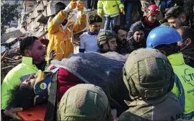  ?? CEMAL YURTTAS/DIA VIA AP ?? Turkish army commandos and medics rescue a woman from a collapsed building in Hatay, southern Turkey, Wednesday, Feb. 8, 2023. Freezing cold temperatur­es are hindering rescue teams as they work to save people still trapped in the rubble after a 7.8-magnitude earthquake ripped through the region in the early morning hours Monday. Officials expect the number of reported deaths to increase significan­tly as operations continue.