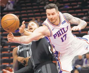  ?? PAUL SANCYA/AP ?? Philadelph­ia 76ers guard JJ Redick is fouled by Detroit Pistons forward Blake Griffin (23) in the second half of Friday’s game. The Sixers won 117-111.