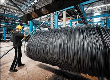  ?? GETTY-AFP ?? A worker handles steel cable Friday at a Chinese factory. China says it’s responding in “equal scale” to U.S. trade action.