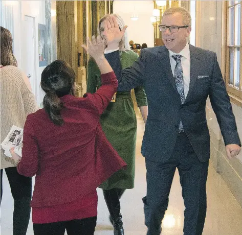  ?? TROY FLEECE ?? Premier Brad Wall high-fives a staff member after his last question period as premier at the Legislativ­e Building on Wednesday.