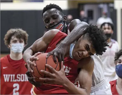  ?? BEN HASTY — READING EAGLE ?? Wilson’s Stevie Mitchell tries to hold onto the ball against Reading High’s Moro Osumanu during the District 3Class 6A title game.