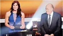 ??  ?? Hope Solo and Sepp Blatter at the Ballon d’or awards ceremony in 2013