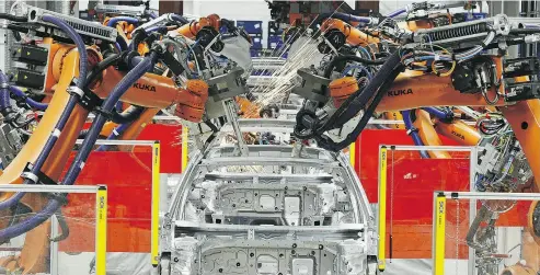  ?? JENS MEYER / THE ASSOCIATED PRESS FILES ?? Robots weld Golf car bodies at the Volkswagen plant in Zwickau, central Germany. VW plans to boost battery-vehicle production at Zwickau beyond 100,000 vehicles annually and might add e-cars in Emden, sources say.