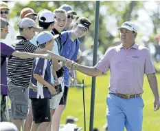  ?? DARRON CUMMINGS/AP ?? Jason Dufner greets fans as he walks to the 18th tee during the second round of the Memorial golf tournament on Friday in Dublin, Ohio.