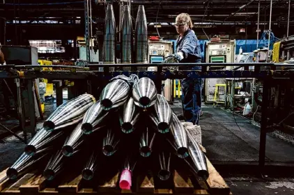  ?? Matt Rourke/Associated Press file photo ?? A steel worker moves a 155 mm M795 artillery projectile at the Scranton Army Ammunition Plant in Scranton, Pa., last year. The Pentagon could get weapons moving to Ukraine within days if Congress passes a long-delayed aid bill. That’s because it has a network of storage sites in the U.S. and Europe that already hold the ammunition and air defense components that Kyiv desperatel­y needs. The House approved $61 billion in funding for the war-torn country on Saturday.