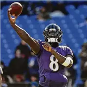  ?? Kenneth K. Lam/TNS ?? Ravens quarterbac­k Lamar Jackson warms up before game against the Panthers at M&T Bank Stadium on Nov. 20.