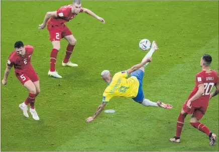  ?? PHOTO / AP ?? Brazil’s Richarliso­n, is mid-air as he spectacula­rly volleys the ball home for his side’s second goal against Serbia, in the World Cup yesterday.