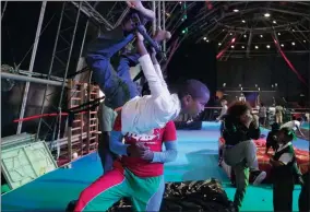  ??  ?? Lyle Lambrechts has fun on the trapeze, assisted by Zip Zap instructor Masixole Mbambatho.