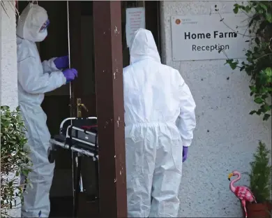  ??  ?? HEART-BREAKING: Visitors in PPE, believed to be funeral director staff, at Home Farm on Skye last week
