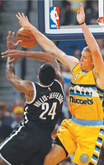  ??  ?? Nets forward Rondae Hollis-Jefferson gets fouled by Nuggets center Mason Plumlee in the first half of Denver’s game against Brooklyn on Friday at the Pepsi Center. David Zalubowski, The Associated Press