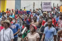  ?? VALERIE BAERISWYL/AFP VIA GETTY IMAGES ?? Haitians take to the streets to protest over the increasing insecurity in the Haitian capital Port-au-Prince on March 29.