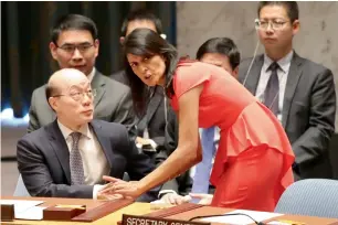  ??  ?? American Ambassador to the United Nations Nikki Haley, right, speaks to Chinese Ambassador to the United Nations Liu Jieyu before a Security Council vote on a new sanctions resolution at the UN headquarte­rs in New York. — AP