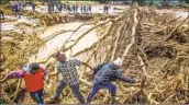  ?? Patrick Ngugi Associated Press ?? PEOPLE clear debris in Kenya’s Mai Mahiu area after a river breached a blocked tunnel, killing 48.