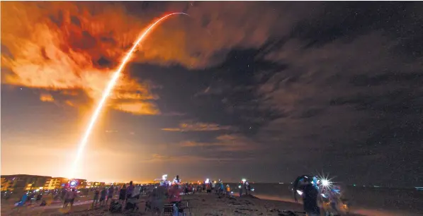  ??  ?? Crowds gather at Kennedy Space Centre in Florida to watch the Spacex flight lift-off carrying, from left, Shannon Walker, Victor Glover, Mike Hopkins and Soichi Noguchi