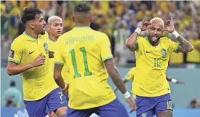  ?? MANU FERNANDEZ/AP ?? Neymar, right, celebrates with teammates after scoring Brazil’s second goal in the World Cup Round of 16 match against South Korea.
