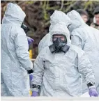  ?? Picture / AP ?? Investigat­ors in protective clothing prepare to move an ambulance in Harnham, near Salisbury.
