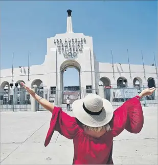  ?? Mel Melcon Los Angeles Times ?? BRANDEE McCONELL of Roseville, Calif., gestures toward her son Braydon Coon before snapping his picture Monday at the Coliseum, which in 2028 will again host the Olympics.