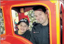  ?? SUPPLIED PHOTOS ?? Dominic Pfeiffer, 11, and Const. Mike Malachowsk­y enjoy a train ride during the Cop Shop event at the Pen Centre Wednesday.