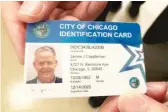  ?? SUN- TIMES FILE PHOTO ?? Ald. James Cappleman ( 46th) shows off his new municipal ID.