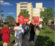  ?? EVAN BRANDT — DIGITAL FIRST MEDIA ?? After rallying along Armand Hammer Boulevard, union nurses and other profession­als marched up to the front door of Pottstown Hospital to protest the closing of the pediatric unit, unsafe staffing levels, the $1 million tax loss to the school district...