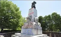  ?? Darrell Sapp/Post-Gazette ?? The statue of Christophe­r Columbus outside Phipps Conservato­ry and Botanical Gardens was vandalized with paint overnight Friday in Oakland.