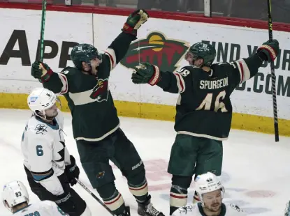  ?? Jim Mone, The Associated Press ?? Minnesota Wild's Kevin Fiala and Jared Spurgeon celebrate Spurgeon's game-winning goal in overtime Sunday in St. Paul, Minn.