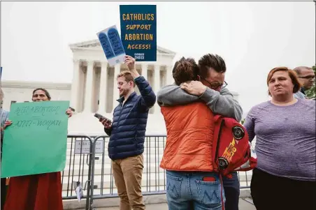  ?? Anna Moneymaker / Getty Images ?? Pro-choice activists embrace as they demonstrat­e in front of the U.S. Supreme Court Building on Tuesday in Washington, D.C.