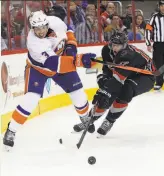  ?? Chris Seward / Raleigh (N.C.) News & Observer ?? Longtime Islanders defenseman Travis Hamonic (left) was traded to the Calgary Flames.