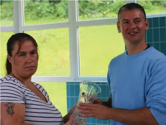  ??  ?? Margaret Maughan presents Eamon Kelly with a piece of crystal in recognitio­n of his quick action of saving her son Owen’s life.