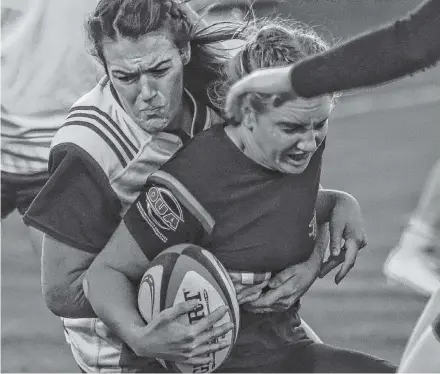  ?? Gary Manning ?? Sarah Mccarron of the St. F.X. X-women makes a tackle on her Guelph Gryphons’ opponent during the 2018 U Sports rugby national championsh­ip game at Acadia in Wolfville.