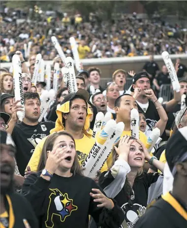  ?? Haley Nelson/Post-Gazette ?? Fans react Monday outside Consol Energy Center after the Penguins nearly score a goal in Game 1 of the Stanley Cup final against the San Jose Sharks. A third-period goal by Nick Bonino sent the Penguins to a 3-2 victory and an early series lead.