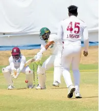  ?? PHOTO BY LENNOX ALDRED ?? Jamaica Scorpions batman Brandon King (centre) bats against West Indies Academy bowler Joshua Bishop (right) during their West Indies Championsh­ip clash at Sabina Park yesterday. Academy wicketkeep­er Carlon Bowen-Tuckett looks on.