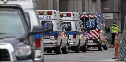  ?? MATT STONE / HERALD STAFF FILE ?? CLOSE TO HOME: Ambulances lined up at Brigham and Women’s Hospital on Friday after many suspected coronaviru­s patients were brought in from a Biogen conference.